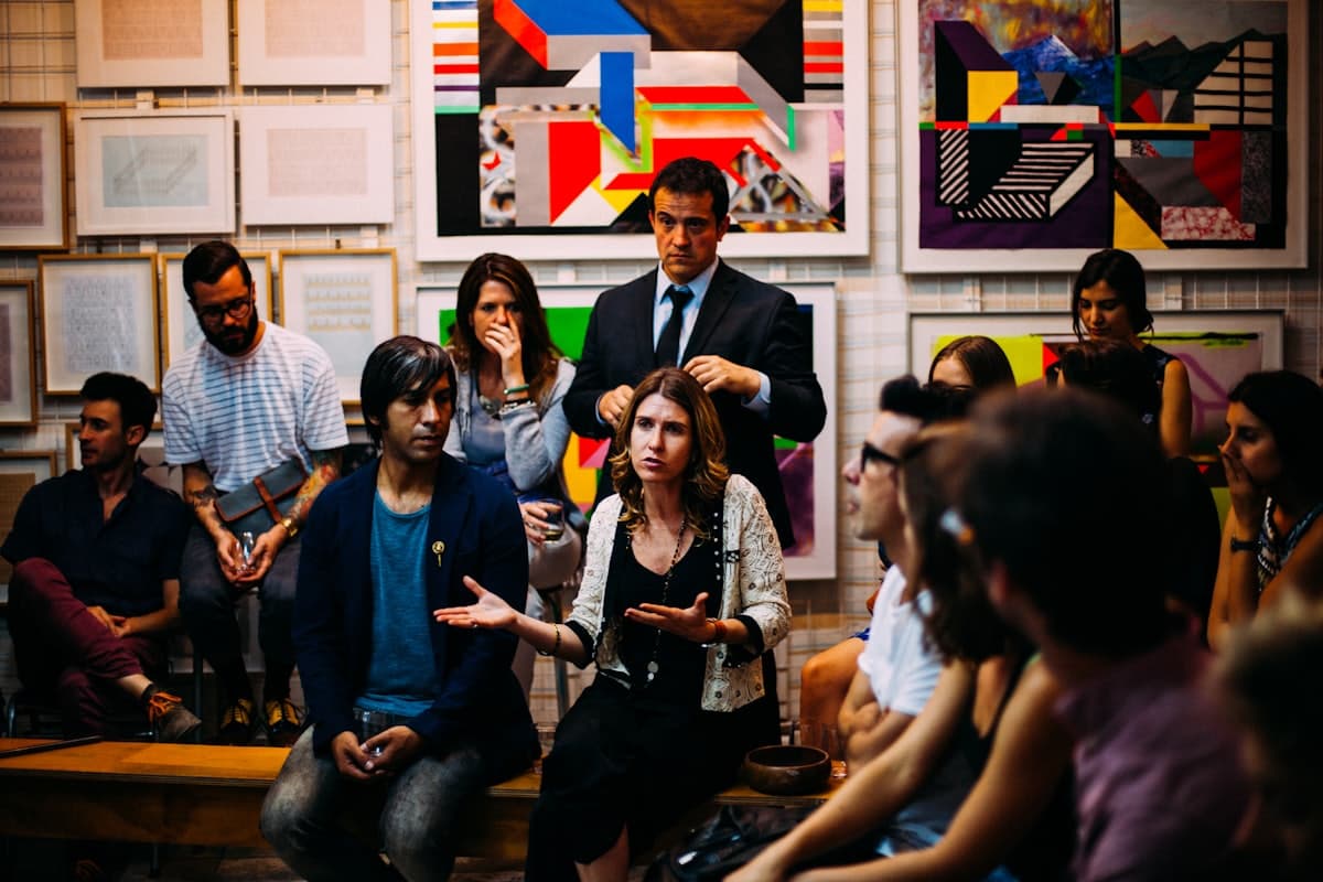 Founders gathered in a room listening to a speaker